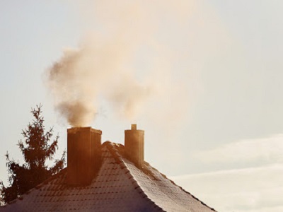 a very cold night thick smoke from its chimney smoke